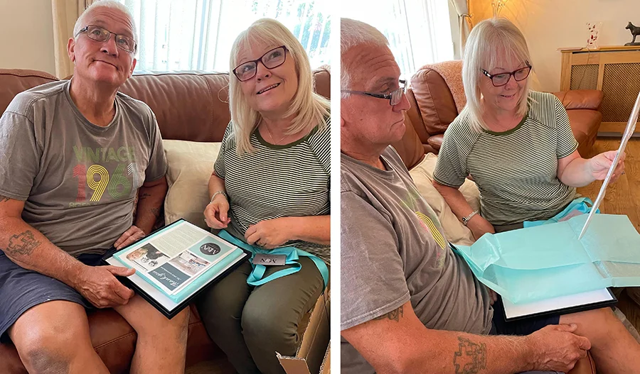 Parents reacting emotionally to opening Kegan's pet portrait, close to tears.