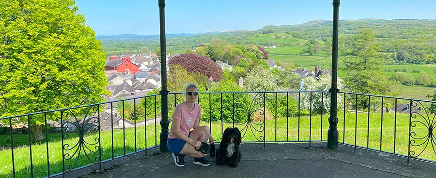 Melanie and her dog Lily standing near the bandstand in Llandeilo, Wales.