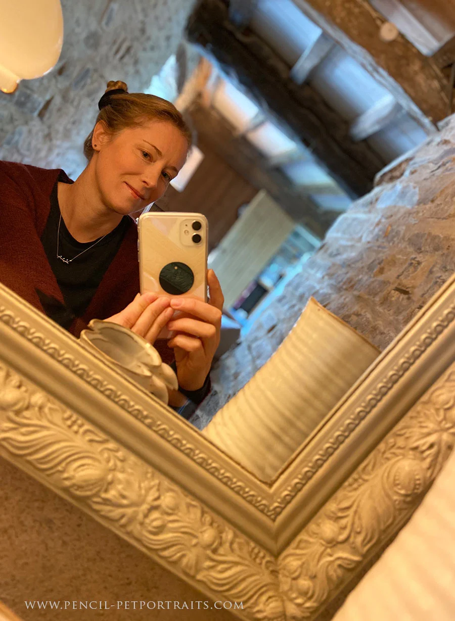 Melanie taking a selfie reflection in a mirror.