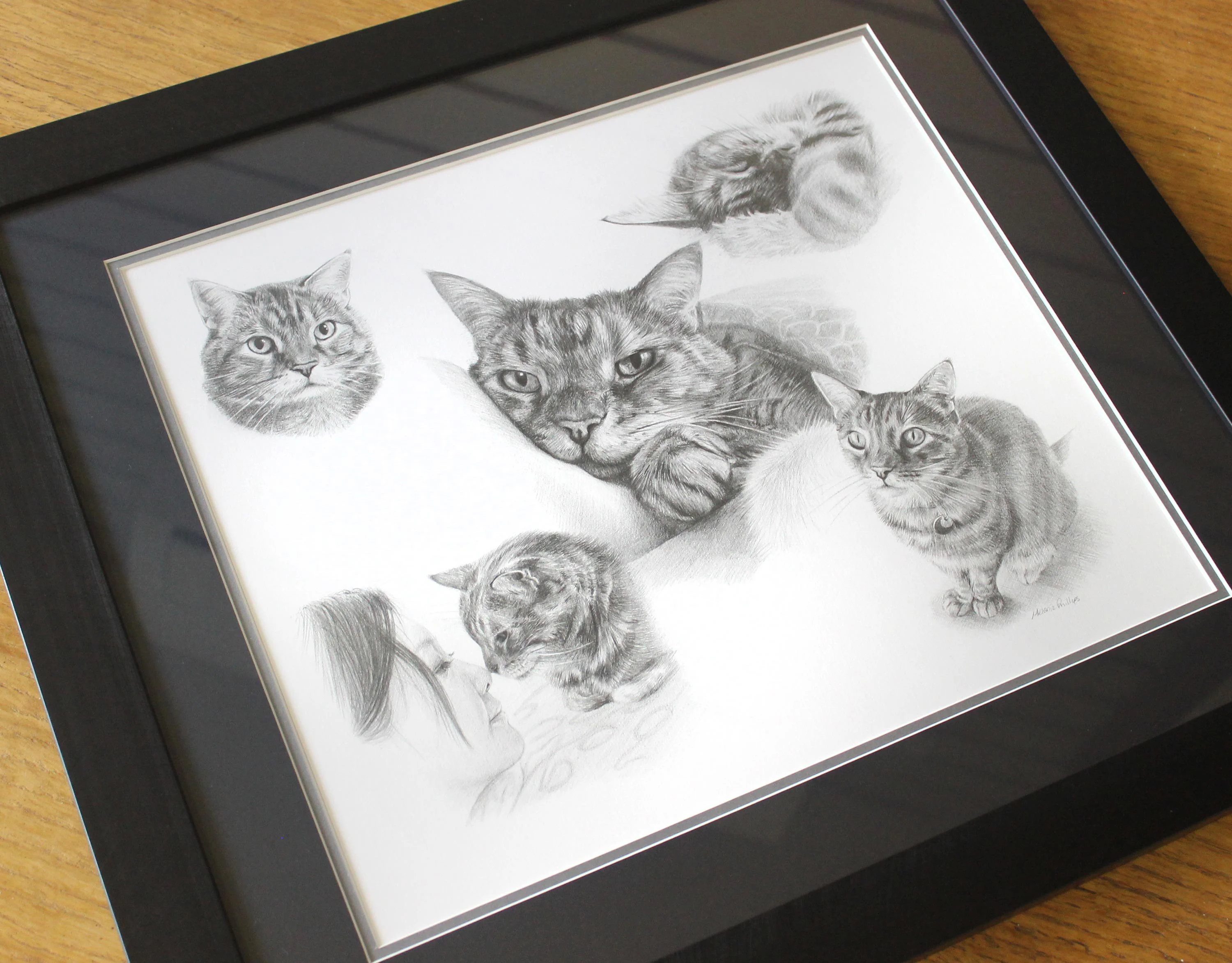 The custom cat Life Story Portrait portrait of Gilli displayed on its unique stand.